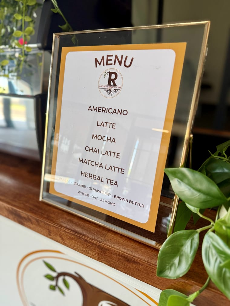 A framed custom menu board carrying a client logo.