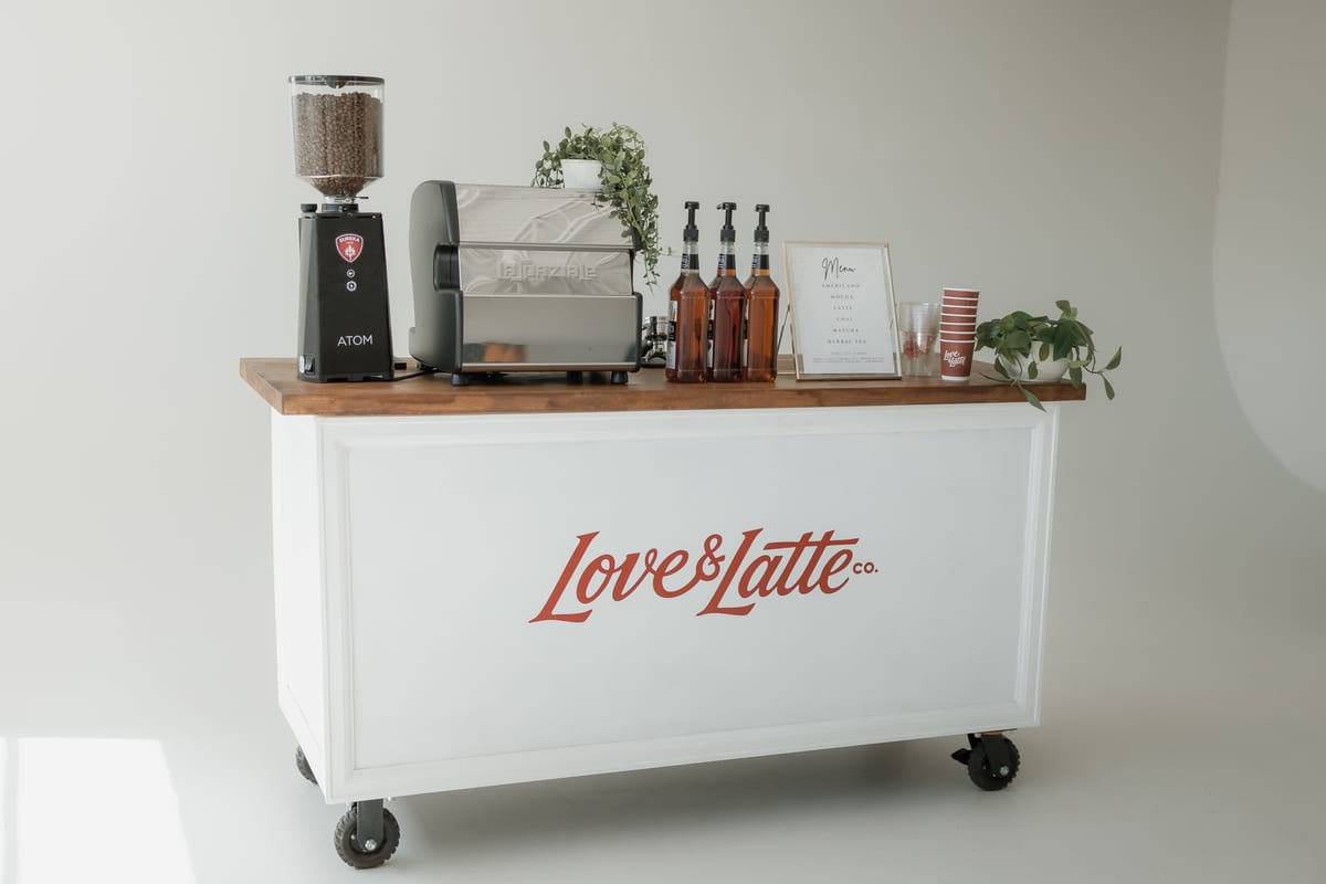 The Love and Latte cart with the espresso machine, grinder and syrups set up ready to serve