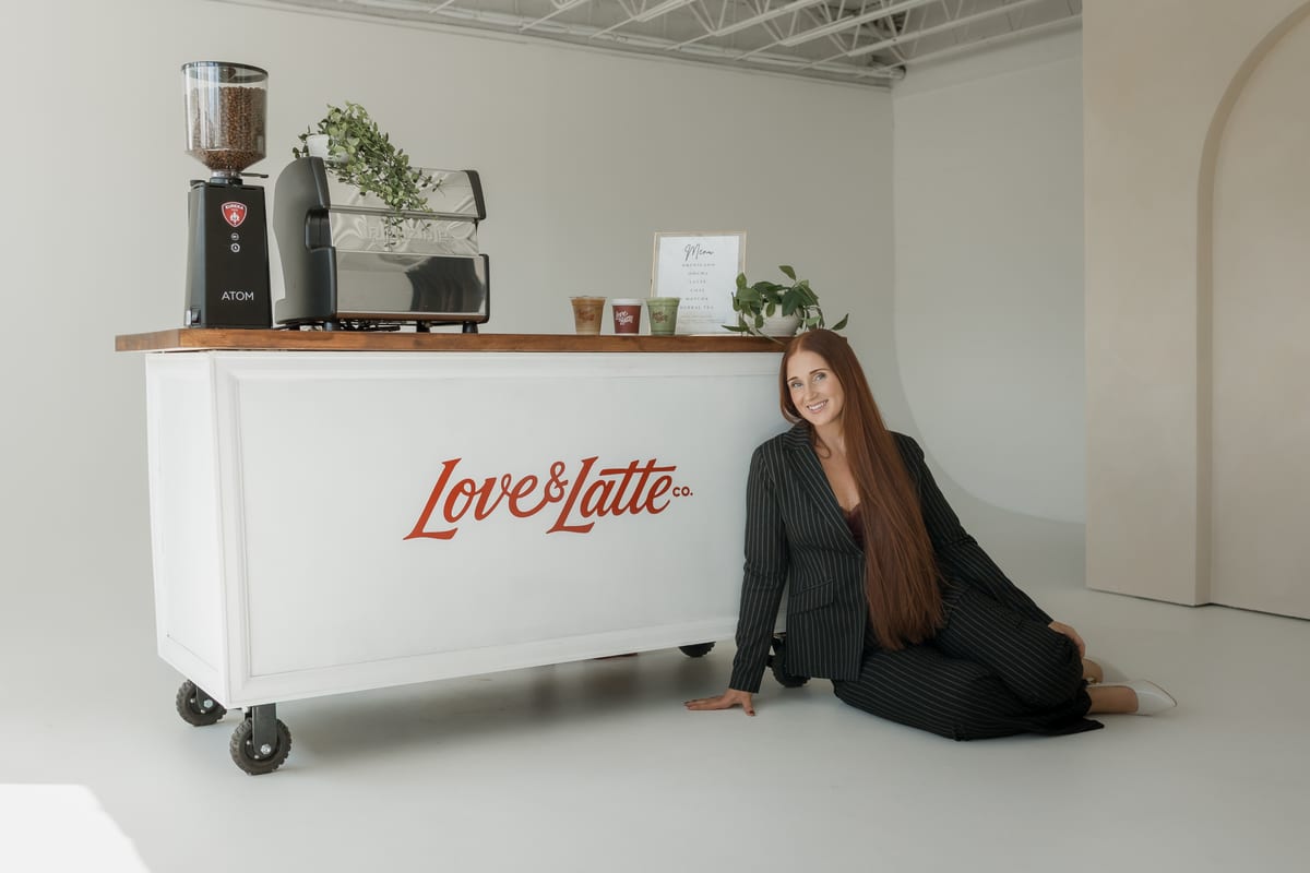 Julia, the owner of Love and Latte, sitting in front of the cart
