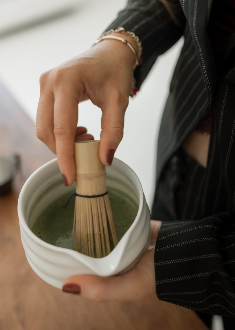 Ceremonial matcha being whisked in a bowl.