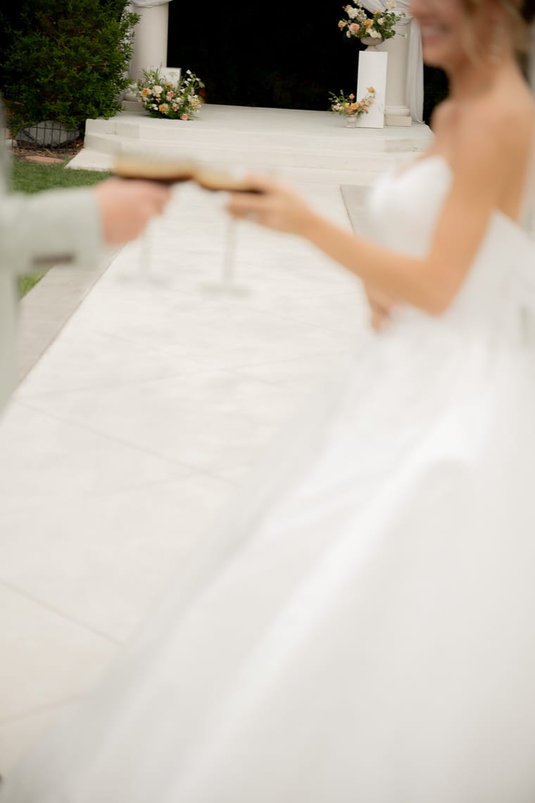 A bride carrying a tray of drinks from the cart.